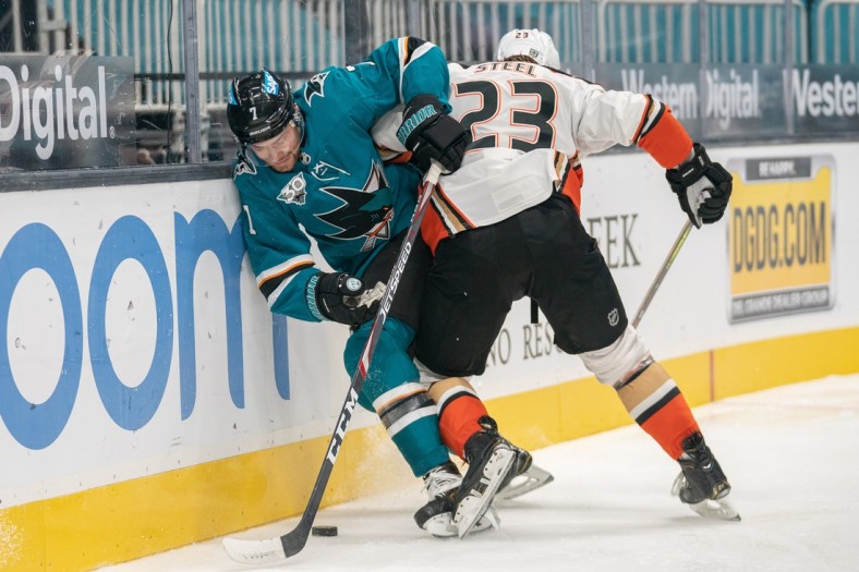 Feb 15, 2021; San Jose, California, USA;  San Jose Sharks center Dylan Gambrell (7) and Anaheim Ducks center Sam Steel (23) fight for control of the puck during the first period at SAP Center at San Jose. Mandatory Credit: Stan Szeto-USA TODAY Sports