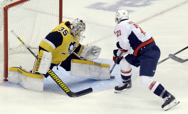 Feb 16, 2021; Pittsburgh, Pennsylvania, USA;  Pittsburgh Penguins goaltender Tristan Jarry (35) makes a save against Washington Capitals right wing Garnet Hathaway (21) during the first period at PPG Paints Arena. Mandatory Credit: Charles LeClaire-USA TODAY Sports