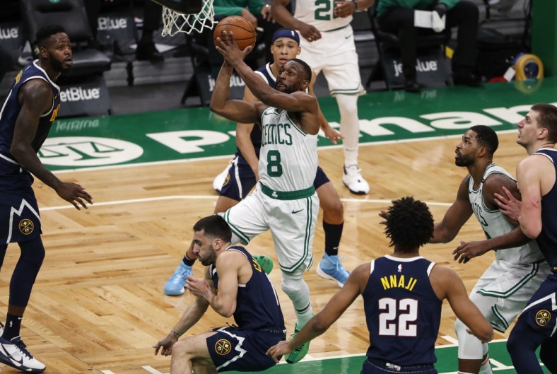 Feb 16, 2021; Boston, Massachusetts, USA; Boston Celtics guard Kemba Walker (8) drives to the basket over Denver Nuggets guard Facundo Campazzo (7) during the first quarter at TD Garden. Mandatory Credit: Winslow Townson-USA TODAY Sports