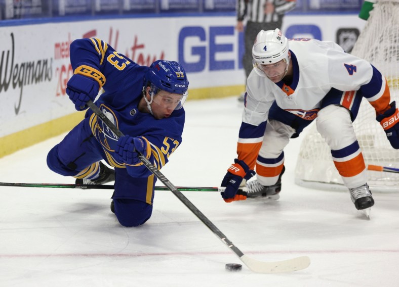 Feb 16, 2021; Buffalo, New York, USA;  New York Islanders defenseman Andy Greene (4) watches as Buffalo Sabres left wing Jeff Skinner (53) dives to make a pass during the second period at KeyBank Center. Mandatory Credit: Timothy T. Ludwig-USA TODAY Sports