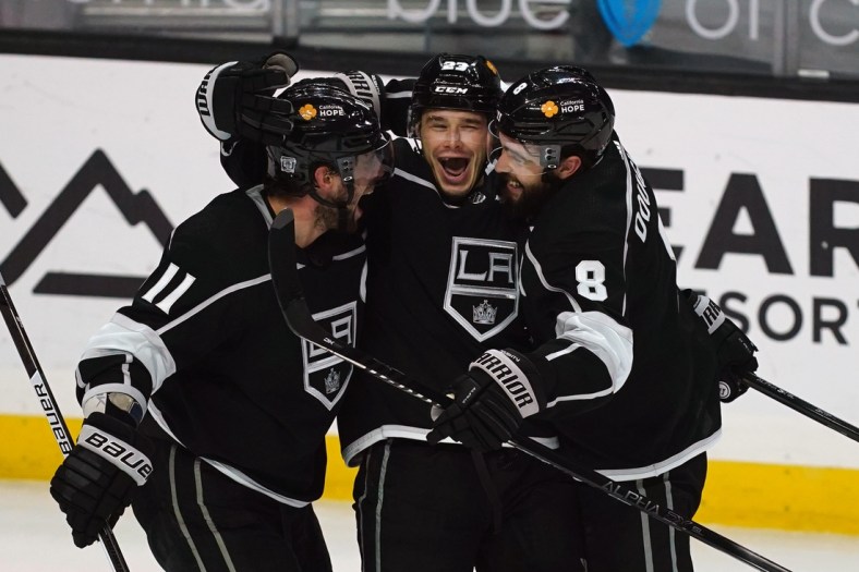 Feb 16, 2021; Los Angeles, California, USA; LA Kings right wing Dustin Brown (23) celebrates with center Anze Kopitar (11) and defenseman Drew Doughty (8) after scoring a goal against the Minnesota Wild in the third period at Staples Center. Mandatory Credit: Kirby Lee-USA TODAY Sports