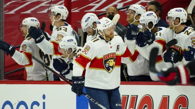 Feb 17, 2021; Raleigh, North Carolina, USA;  Florida Panthers left wing Jonathan Huberdeau (11) is congratulated after scoring a goal against the Carolina Hurricanes during the second period at PNC Arena. Mandatory Credit: James Guillory-USA TODAY Sports