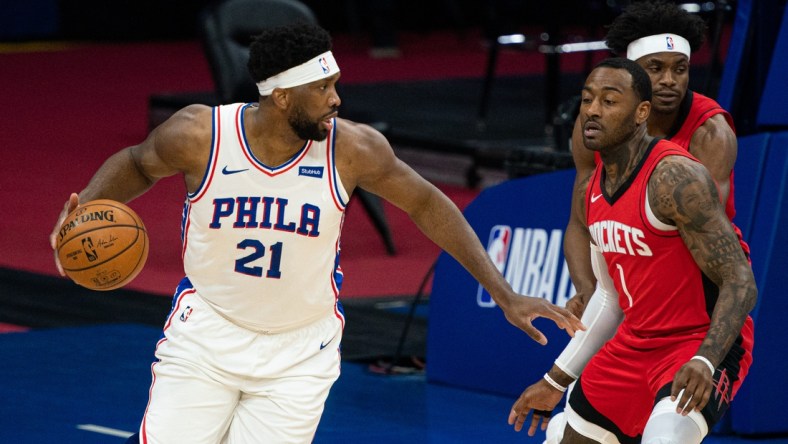 Feb 17, 2021; Philadelphia, Pennsylvania, USA; Philadelphia 76ers center Joel Embiid (21) controls the ball against Houston Rockets guard John Wall (1) during the first quarter at Wells Fargo Center. Mandatory Credit: Bill Streicher-USA TODAY Sports