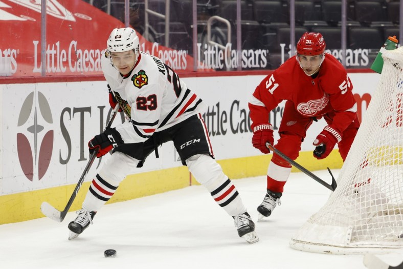 Feb 17, 2021; Detroit, Michigan, USA;  Chicago Blackhawks left wing Philipp Kurashev (23) skates with the puck against Detroit Red Wings center Valtteri Filppula (51) in the first period at Little Caesars Arena. Mandatory Credit: Rick Osentoski-USA TODAY Sports