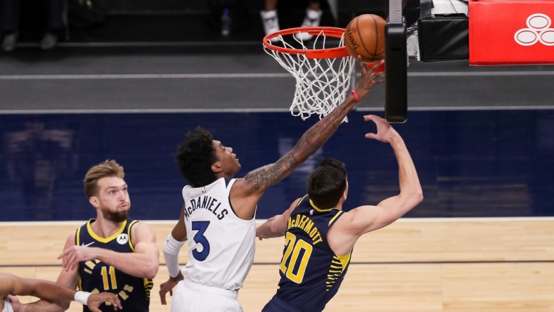 Feb 17, 2021; Minneapolis, Minnesota, USA; Minnesota Timberwolves forward Jaden McDaniels (3) blocks the shot of Indiana Pacers forward Doug McDermott (20) in the first quarter at Target Center. Mandatory Credit: Brad Rempel-USA TODAY Sports