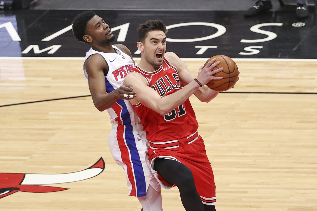 Feb 17, 2021; Chicago, Illinois, USA; Chicago Bulls guard Tomas Satoransky (31) goes to the basket past Detroit Pistons guard Josh Jackson (20) during the first half of an NBA game at United Center. Mandatory Credit: Kamil Krzaczynski-USA TODAY Sports