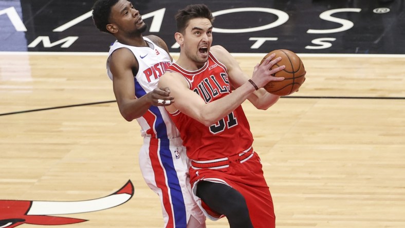 Feb 17, 2021; Chicago, Illinois, USA; Chicago Bulls guard Tomas Satoransky (31) goes to the basket past Detroit Pistons guard Josh Jackson (20) during the first half of an NBA game at United Center. Mandatory Credit: Kamil Krzaczynski-USA TODAY Sports