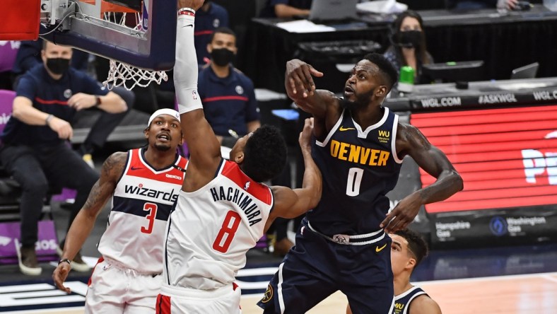 Feb 17, 2021; Washington, District of Columbia, USA; Denver Nuggets forward JaMychal Green (0) blocks the shot of Washington Wizards forward Rui Hachimura (8) during the second quarter at Capital One Arena. Mandatory Credit: Brad Mills-USA TODAY Sports