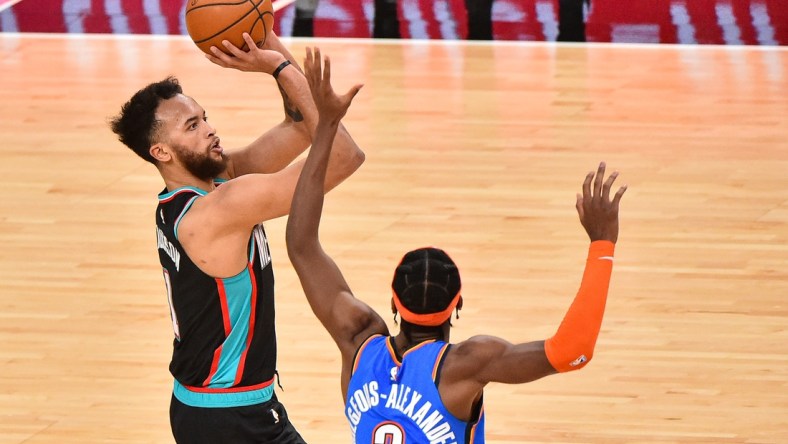 Feb 17, 2021; Memphis, Tennessee, USA; Memphis Grizzlies forward Kyle Anderson (1) shoots the ball against Oklahoma City Thunder guard Shai Gilgeous-Alexander (2) during the first half at FedExForum. Mandatory Credit: Justin Ford-USA TODAY Sports