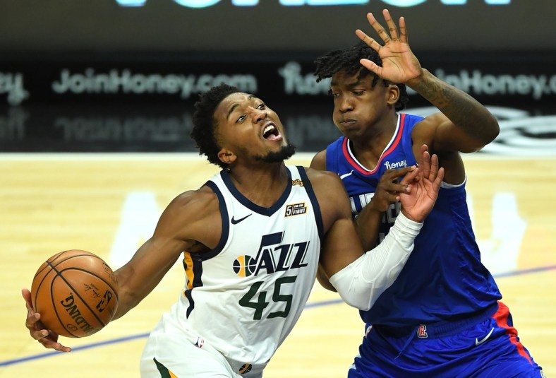 Feb 17, 2021; Los Angeles, California, USA; Utah Jazz guard Donovan Mitchell (45) is defended by Los Angeles Clippers guard Terance Mann (14) as he drives to the basket in the second half of the game at Staples Center. Mandatory Credit: Jayne Kamin-Oncea-USA TODAY Sports