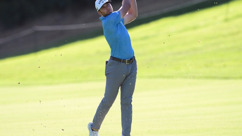 Feb 18, 2021; Pacific Palisades, California, USA; Sam Burns plays his shot on the eighteenth hole fairway during the first round of The Genesis Invitational golf tournament at Riviera Country Club. Mandatory Credit: Gary A. Vasquez-USA TODAY Sports