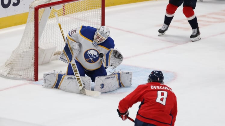 Feb 18, 2021; Washington, District of Columbia, USA; Buffalo Sabres goaltender Linus Ullmark (35) makes a save on Washington Capitals left wing Alex Ovechkin (8) in the first period at Capital One Arena. Mandatory Credit: Geoff Burke-USA TODAY Sports