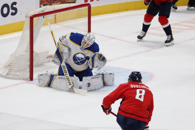 Feb 18, 2021; Washington, District of Columbia, USA; Buffalo Sabres goaltender Linus Ullmark (35) makes a save on Washington Capitals left wing Alex Ovechkin (8) in the first period at Capital One Arena. Mandatory Credit: Geoff Burke-USA TODAY Sports