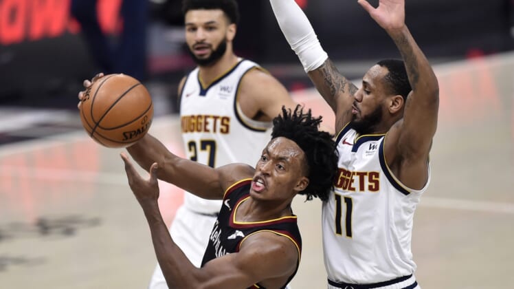 Feb 19, 2021; Cleveland, Ohio, USA; Cleveland Cavaliers guard Collin Sexton (2) drives against Denver Nuggets guard Monte Morris (11) in the second quarter at Rocket Mortgage FieldHouse. Mandatory Credit: David Richard-USA TODAY Sports