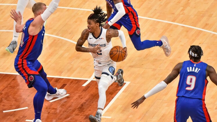 Feb 19, 2021; Memphis, Tennessee, USA; Memphis Grizzlies guard Ja Morant (12) goes to the basket against Detroit Pistons center Mason Plumlee (24) during the first half at FedExForum. Mandatory Credit: Justin Ford-USA TODAY Sports