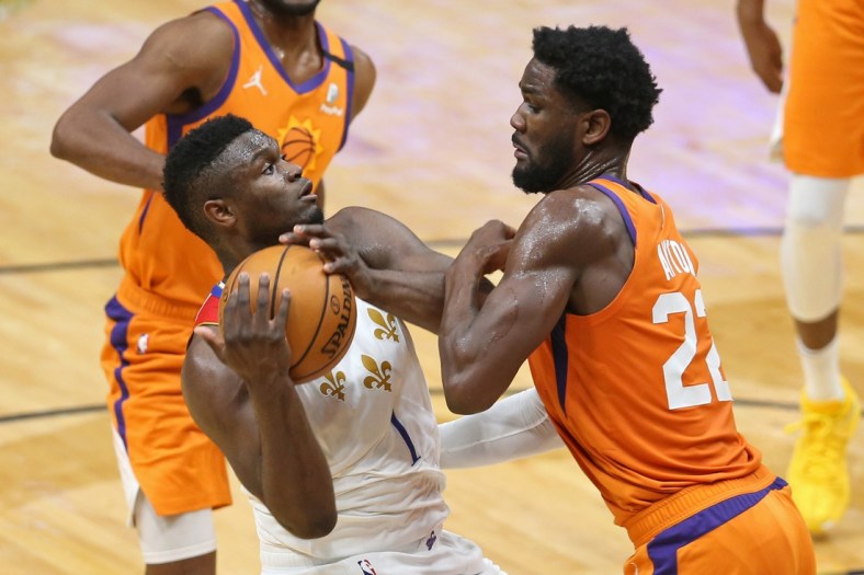 Feb 19, 2021; New Orleans, Louisiana, USA; New Orleans Pelicans forward Zion Williamson (1) is defended by Phoenix Suns center Deandre Ayton (22) in the second quarter at the Smoothie King Center. Mandatory Credit: Chuck Cook-USA TODAY Sports