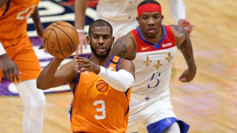 Feb 19, 2021; New Orleans, Louisiana, USA; Phoenix Suns guard Chris Paul (3) passes while defend by New Orleans Pelicans guard Eric Bledsoe (5) in the third quarter at the Smoothie King Center. Mandatory Credit: Chuck Cook-USA TODAY Sports