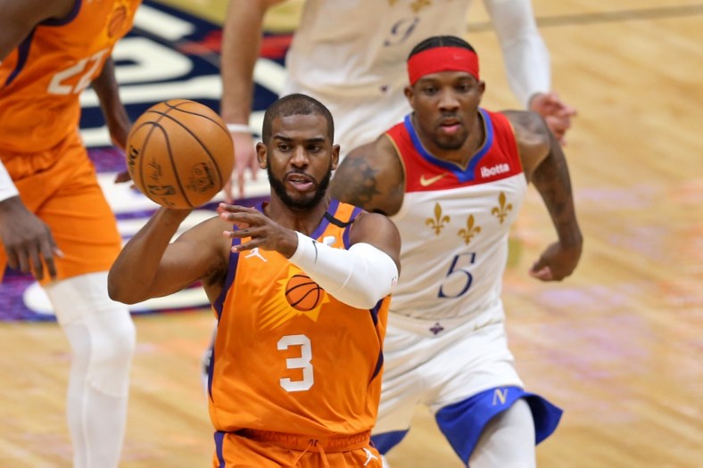 Feb 19, 2021; New Orleans, Louisiana, USA; Phoenix Suns guard Chris Paul (3) passes while defend by New Orleans Pelicans guard Eric Bledsoe (5) in the third quarter at the Smoothie King Center. Mandatory Credit: Chuck Cook-USA TODAY Sports