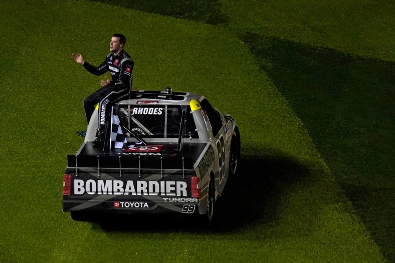 Feb 19, 2021; Daytona Beach, FL, USA; NASCAR Truck Series driver Ben Rhodes (99) sits on his truck after celebrating his win in the Brake Best Select 159 at the Daytona International Speedway Road Course. Mandatory Credit: Jasen Vinlove-USA TODAY Sports