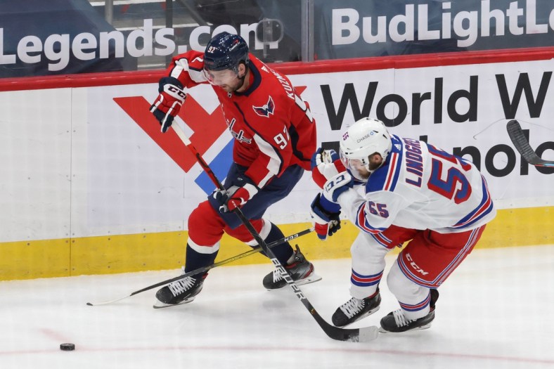 Feb 20, 2021; Washington, District of Columbia, USA; Washington Capitals center Evgeny Kuznetsov (92). Skates with the puck as New York Rangers defenseman Ryan Lindgren (55) defends in the first period at Capital One Arena. Mandatory Credit: Geoff Burke-USA TODAY Sports