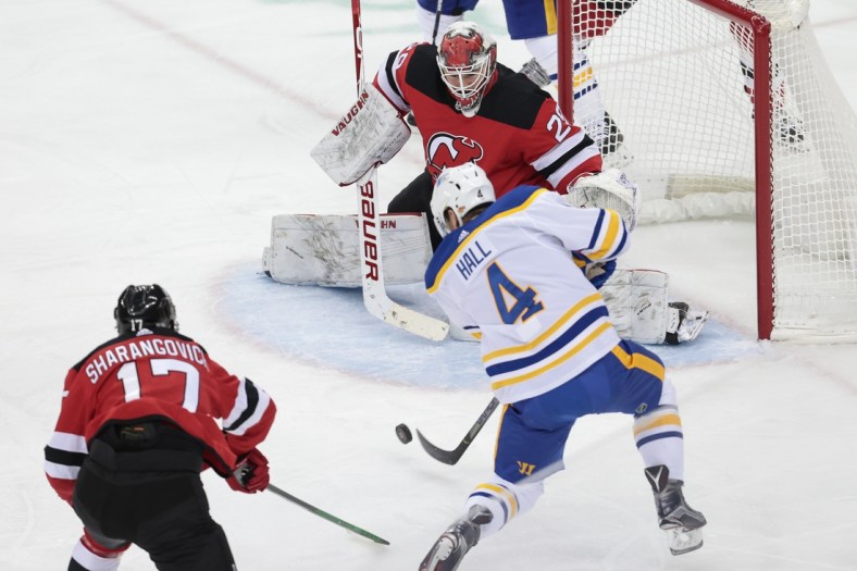 Feb 20, 2021; Newark, New Jersey, USA; Buffalo Sabres left wing Taylor Hall (4) shoots the puck at New Jersey Devils goaltender Mackenzie Blackwood (29) during the first period at Prudential Center. Mandatory Credit: Vincent Carchietta-USA TODAY Sports