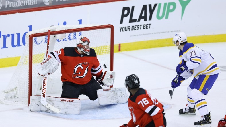 Feb 20, 2021; Newark, New Jersey, USA; Buffalo Sabres center Sam Reinhart (23) shoots the puck past New Jersey Devils goaltender Mackenzie Blackwood (29) for a goal during the second period at Prudential Center. Mandatory Credit: Vincent Carchietta-USA TODAY Sports