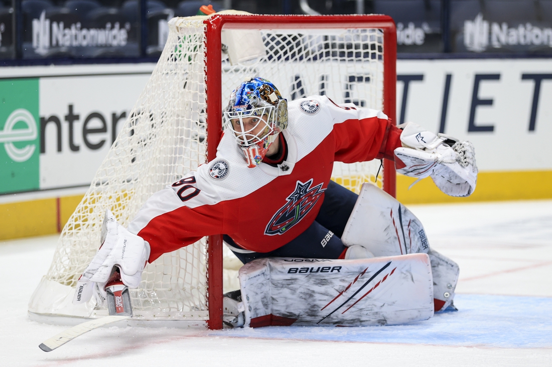 Feb 20, 2021; Columbus, Ohio, USA; Columbus Blue Jackets goaltender Elvis Merzlikins (90) reaches with his stick to defend the net against the Nashville Predators in the second period at Nationwide Arena. Mandatory Credit: Aaron Doster-USA TODAY Sports