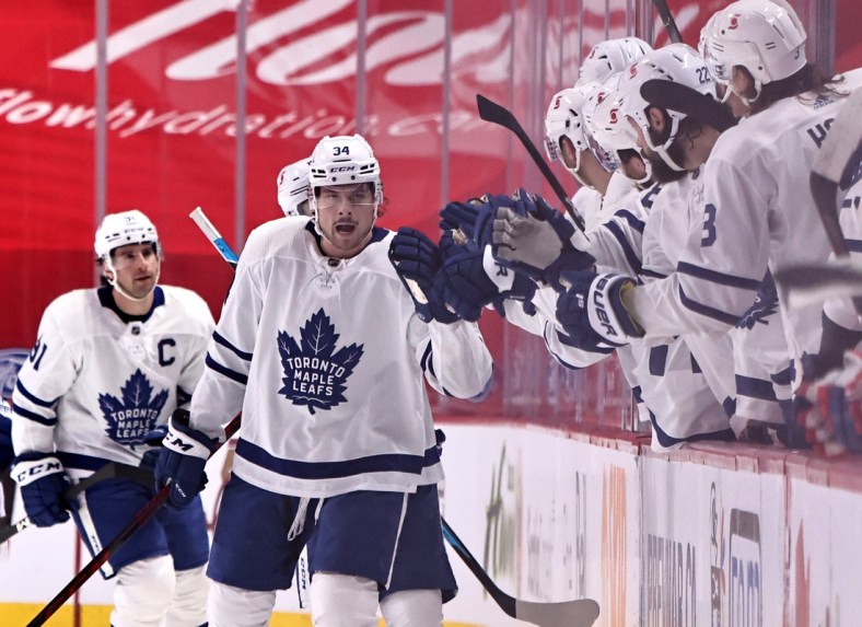 Feb 20, 2021; Montreal, Quebec, CAN; Toronto Maple Leafs center Auston Matthews (34) celebrates his goal against Montreal Canadiens with teammates during the second period at Bell Centre. Mandatory Credit: Jean-Yves Ahern-USA TODAY Sports