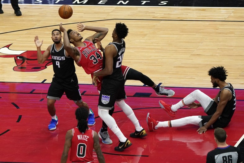 Feb 20, 2021; Chicago, Illinois, USA; Chicago Bulls center Wendell Carter Jr. (34) shoots the ball against Sacramento Kings center Hassan Whiteside (20) during the first quarter at the United Center. Mandatory Credit: Mike Dinovo-USA TODAY Sports