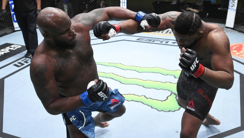 Feb 20, 2021; Las Vegas, NV, USA;   Derrick Lewis and Curtis Blaydes trade punches in a heavyweight bout during the UFC Fight Night event at UFC APEX on February 20, 2021 in Las Vegas, Nevada.  Mandatory Credit: Chris Unger/Handout Photo via USA TODAY Sports