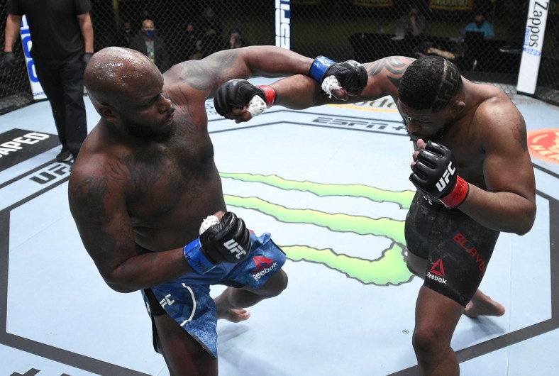 Feb 20, 2021; Las Vegas, NV, USA;   Derrick Lewis and Curtis Blaydes trade punches in a heavyweight bout during the UFC Fight Night event at UFC APEX on February 20, 2021 in Las Vegas, Nevada.  Mandatory Credit: Chris Unger/Handout Photo via USA TODAY Sports