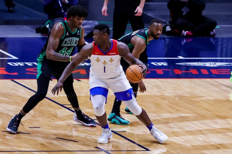 Feb 21, 2021; New Orleans, Louisiana, USA;  New Orleans Pelicans forward Zion Williamson (1) dribbles against Boston Celtics center Robert Williams III (44) during overtime at the Smoothie King Center. Mandatory Credit: Stephen Lew-USA TODAY Sports