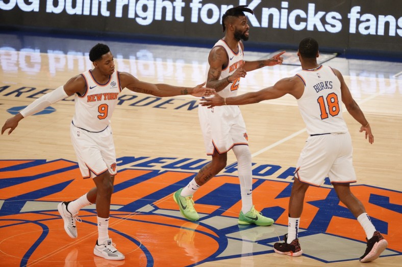 RJ Barrett #9, Reggie Bullock #25, and Alec Burks #18 of the New York Knicks high-five during the second half against the Minnesota Timberwolves at Madison Square Garden on February 21, 2021 in New York City. The Knicks won 103-99.   Mandatory Credit: Sarah Stier/Pool Photo-USA TODAY Sports