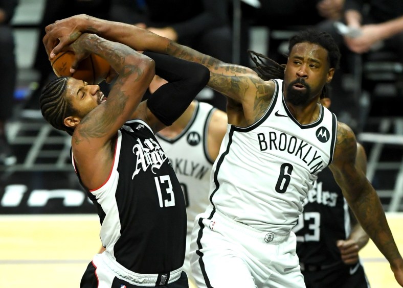 Feb 21, 2021; Los Angeles, California, USA;   Los Angeles Clippers guard Paul George (13) is fouled by Brooklyn Nets center DeAndre Jordan (8) as he goes up for a basket in the fourth quarter of the game at Staples Center. Mandatory Credit: Jayne Kamin-Oncea-USA TODAY Sports