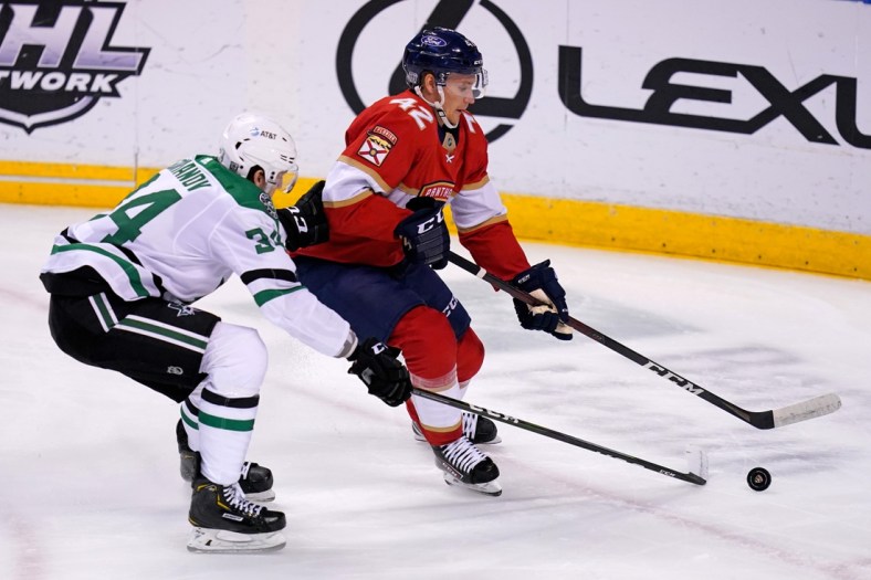 Feb 22, 2021; Sunrise, Florida, USA; Florida Panthers defenseman Gustav Forsling (42) controls the puck away from Dallas Stars right wing Denis Gurianov (34) during the the first period at BB&T Center. Mandatory Credit: Jasen Vinlove-USA TODAY Sports