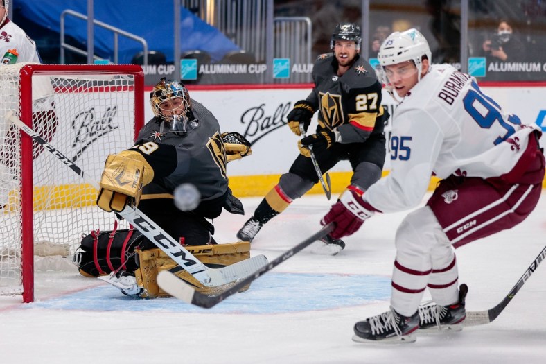 Feb 22, 2021; Denver, Colorado, USA; Vegas Golden Knights goaltender Marc-Andre Fleury (29) and Colorado Avalanche left wing Andre Burakovsky (95) watch as the puck is deflected wide of the net in the first period at Ball Arena. Mandatory Credit: Isaiah J. Downing-USA TODAY Sports