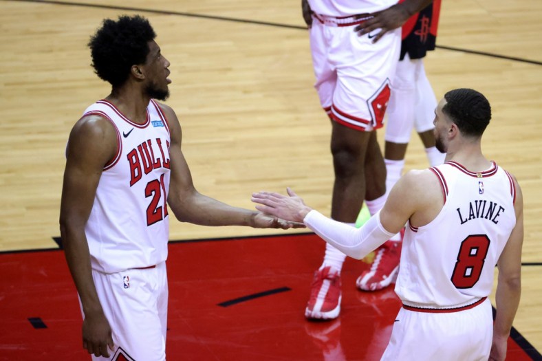 Feb 22, 2021; Houston, Texas, USA; Thaddeus Young #21 high fives Zach LaVine #8 of the Chicago Bulls during the third quarter against the Houston Rockets at Toyota Center. Mandatory Credit: Carmen Mandato/Pool Photo-USA TODAY Sports