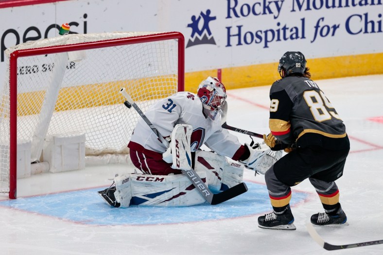 Feb 22, 2021; Denver, Colorado, USA; Vegas Golden Knights right wing Alex Tuch (89) scores on a shot against Colorado Avalanche goaltender Philipp Grubauer (31) in the second period at Ball Arena. Mandatory Credit: Isaiah J. Downing-USA TODAY Sports