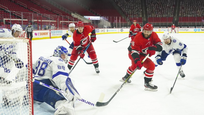 Feb 22, 2021; Raleigh, North Carolina, USA;  Tampa Bay Lightning goaltender Andrei Vasilevskiy (88) stops the shot against Carolina Hurricanes center Vincent Trocheck (16) at PNC Arena. Mandatory Credit: James Guillory-USA TODAY Sports