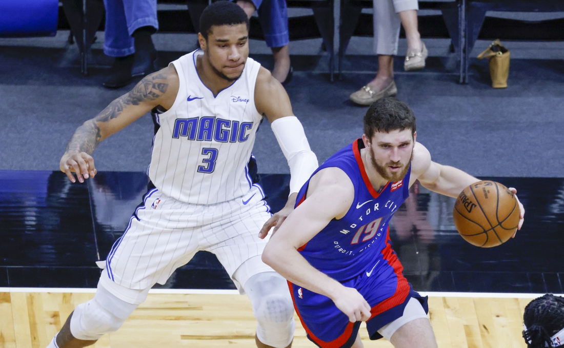 Feb 23, 2021; Orlando, Florida, USA; Detroit Pistons guard Svi Mykhailiuk (19) moves past Orlando Magic forward Chuma Okeke (3)  during the second quarter at Amway Center. Mandatory Credit: Reinhold Matay-USA TODAY Sports