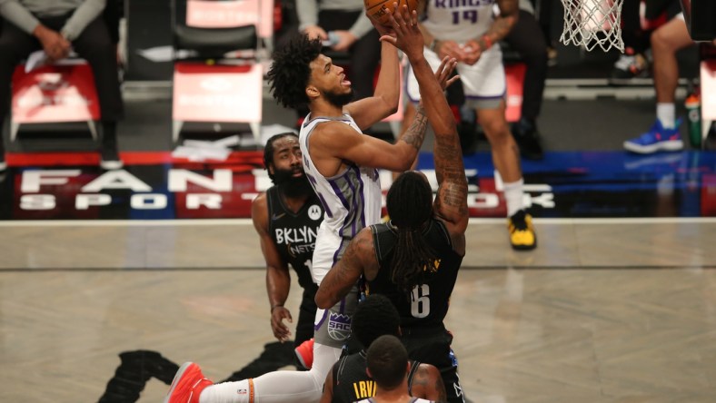 Feb 23, 2021; Brooklyn, New York, USA; Sacramento Kings power forward Marvin Bagley III (35) moves to the basket against Brooklyn Nets shooting guard James Harden (13) and center DeAndre Jordan (6) during the second quarter at Barclays Center. Mandatory Credit: Brad Penner-USA TODAY Sports