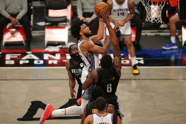 Feb 23, 2021; Brooklyn, New York, USA; Sacramento Kings power forward Marvin Bagley III (35) moves to the basket against Brooklyn Nets shooting guard James Harden (13) and center DeAndre Jordan (6) during the second quarter at Barclays Center. Mandatory Credit: Brad Penner-USA TODAY Sports