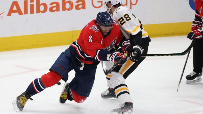 Feb 23, 2021; Washington, District of Columbia, USA; Washington Capitals left wing Alex Ovechkin (8) and Pittsburgh Penguins defenseman Marcus Pettersson (28) battle for the puck in the second period at Capital One Arena. Mandatory Credit: Geoff Burke-USA TODAY Sports