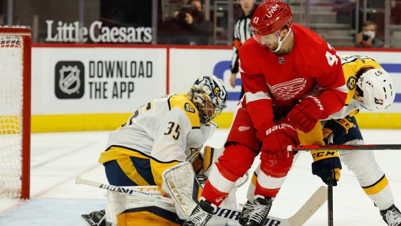 Feb 23, 2021; Detroit, Michigan, USA;  Nashville Predators goaltender Pekka Rinne (35) makes the save ion Detroit Red Wings left wing Darren Helm (43) in the second period  at Little Caesars Arena. Mandatory Credit: Rick Osentoski-USA TODAY Sports