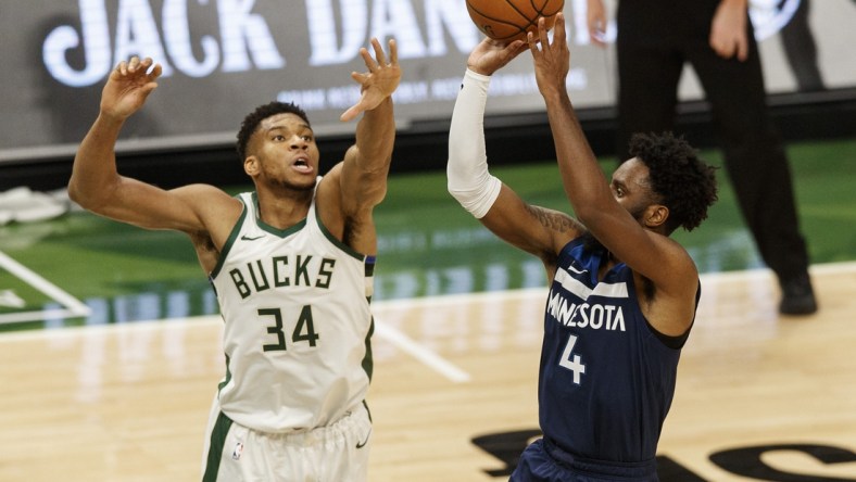 Feb 23, 2021; Milwaukee, Wisconsin, USA;  Milwaukee Bucks forward Giannis Antetokounmpo (34) defends Minnesota Timberwolves guard Jaylen Nowell (4) during the second quarter at Fiserv Forum. Mandatory Credit: Jeff Hanisch-USA TODAY Sports