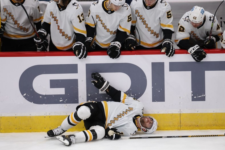 Feb 23, 2021; Washington, District of Columbia, USA; Pittsburgh Penguins left wing Jason Zucker (16) lies on the ice after injuring his left ankle against the Washington Capitals in the third period at Capital One Arena. Mandatory Credit: Geoff Burke-USA TODAY Sports