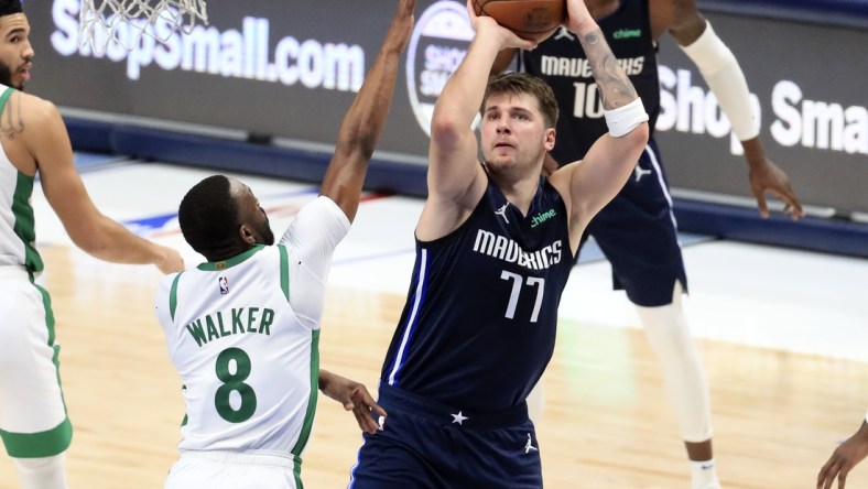 Feb 23, 2021; Dallas, Texas, USA;  Dallas Mavericks guard Luka Doncic (77) shoots over Boston Celtics guard Kemba Walker (8) during the second half at American Airlines Center. Mandatory Credit: Kevin Jairaj-USA TODAY Sports