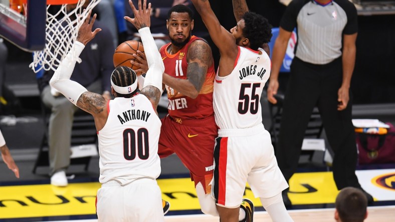 Feb 23, 2021; Denver, Colorado, USA; Portland Trail Blazers forward Carmelo Anthony (00) and forward Derrick Jones Jr. (55) defend on Denver Nuggets guard Monte Morris (11). in the second quarter at Ball Arena. Mandatory Credit: Ron Chenoy-USA TODAY Sports