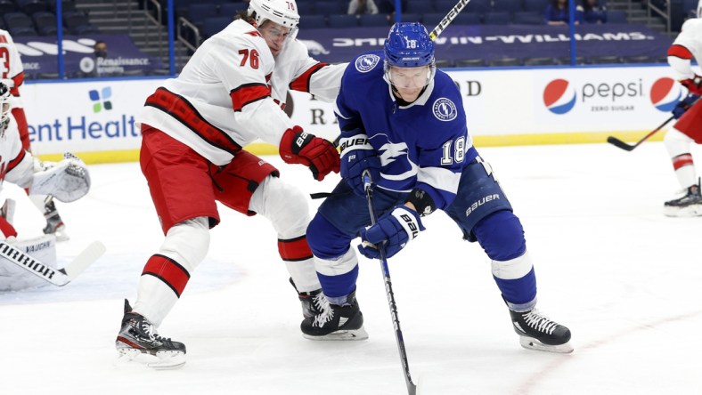 Feb 24, 2021; Tampa, Florida, USA; Tampa Bay Lightning left wing Ondrej Palat (18) skates with the  puck as Carolina Hurricanes defenseman Brady Skjei (76) defends during the first period at Amalie Arena. Mandatory Credit: Kim Klement-USA TODAY Sports