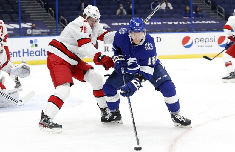 Feb 24, 2021; Tampa, Florida, USA; Tampa Bay Lightning left wing Ondrej Palat (18) skates with the  puck as Carolina Hurricanes defenseman Brady Skjei (76) defends during the first period at Amalie Arena. Mandatory Credit: Kim Klement-USA TODAY Sports